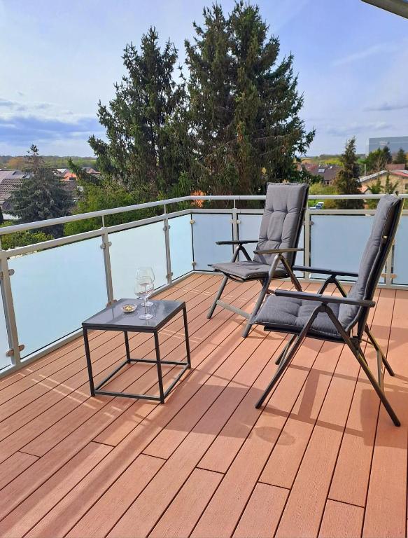 two chairs and a table on a deck at Penthouse Vue Panoramique in Mechernich