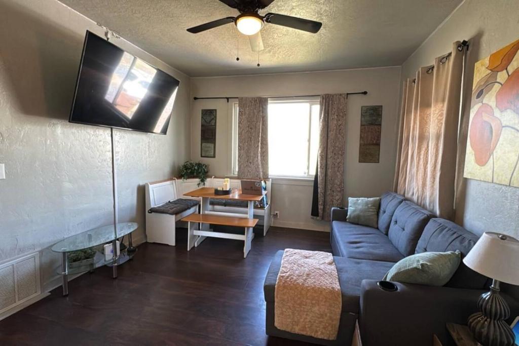 a living room with a blue couch and a table at Value Rental no frills in Midvale