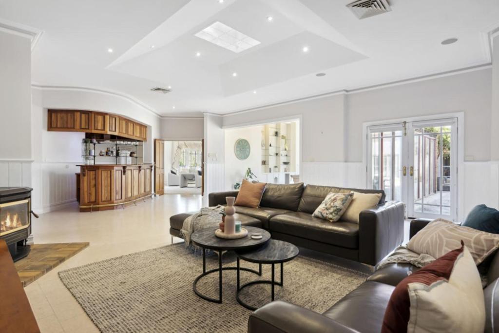a living room with a couch and a table at Peninsula Farm Stay in Somerville