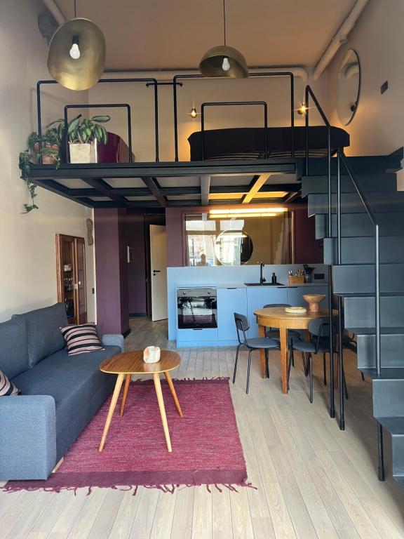 a living room with a loft bed and a dining room at G Loft - Spacious Urban Apartment with Bathtub and Private Entrance in Kaunas