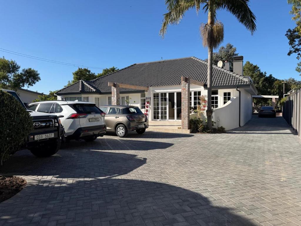 a house with cars parked in front of a driveway at Mia Nina in Heatherlands