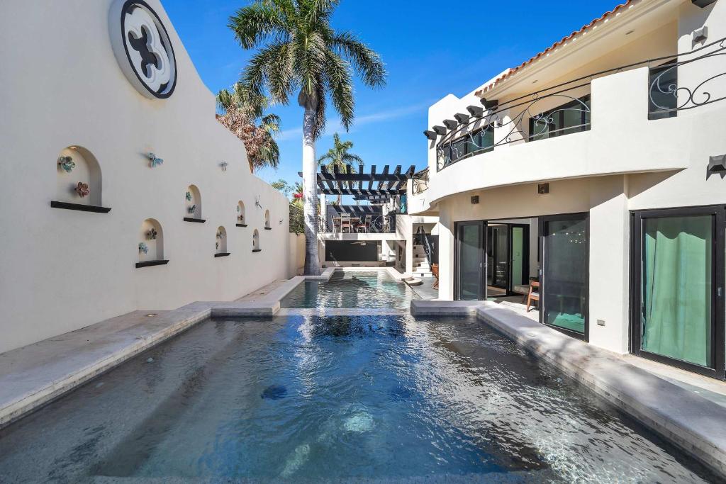 a swimming pool in the middle of a house at Marbella Lane Premium Ocean View Villa & Pool in Cabo San Lucas