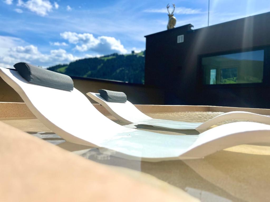 a white chair sitting on top of a building at Goldhirsch Aparthotel in Wagrain