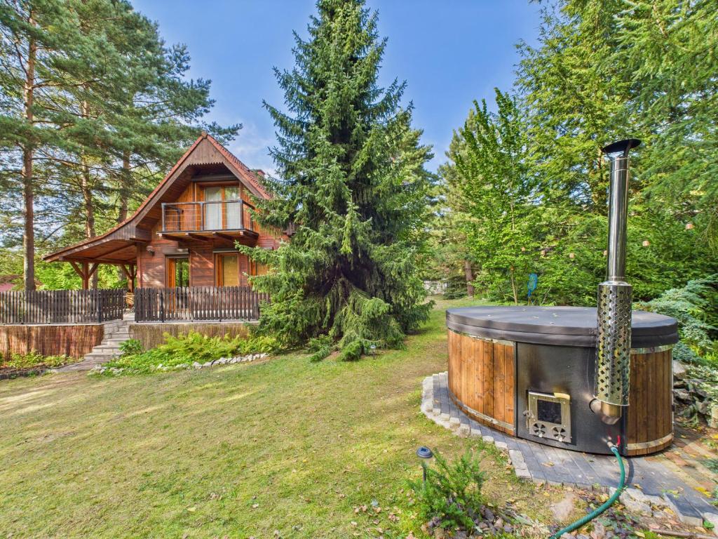 a hot tub in the yard of a log cabin at Chata na Jurze z balią in Zarki Letnisko