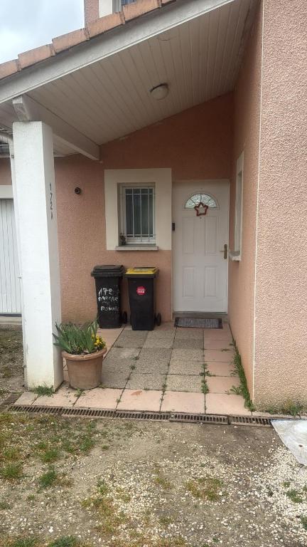 a front porch of a house with a white door at Maison à louer in Valence