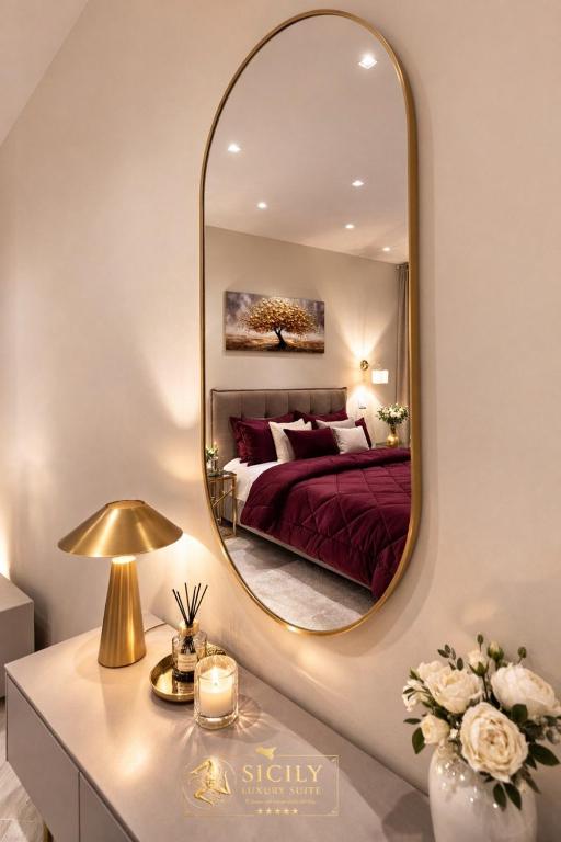 a bedroom with a bed and a large mirror at Sicily Luxury Suites in Palermo