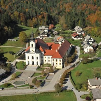 an aerial view of a large white building with red roofs at Hiša Kovač in Velesovo