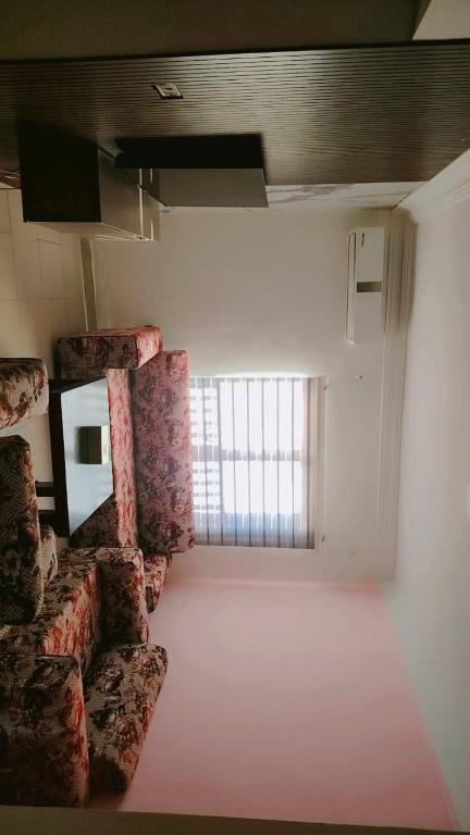 a room with chairs and a window in a room at Taj Plaza in Sowayma