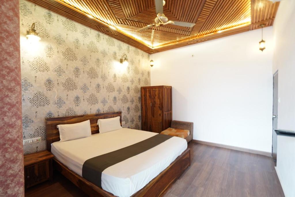 a bedroom with a bed and a ceiling at The Kandarp Villa in Jaipur