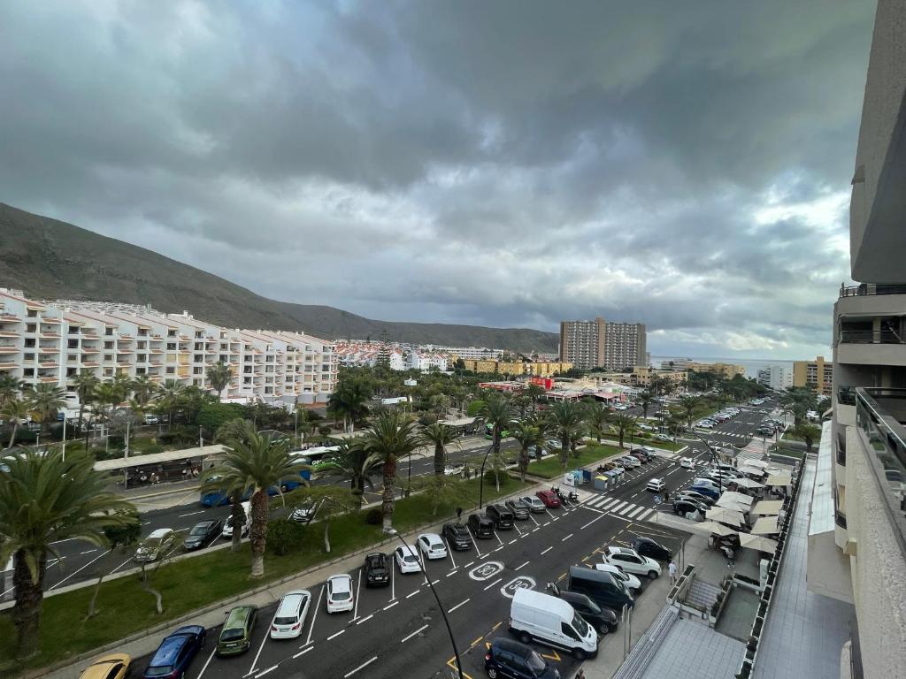 a city with cars parked in a parking lot at Apartmán Centrum in Los Cristianos