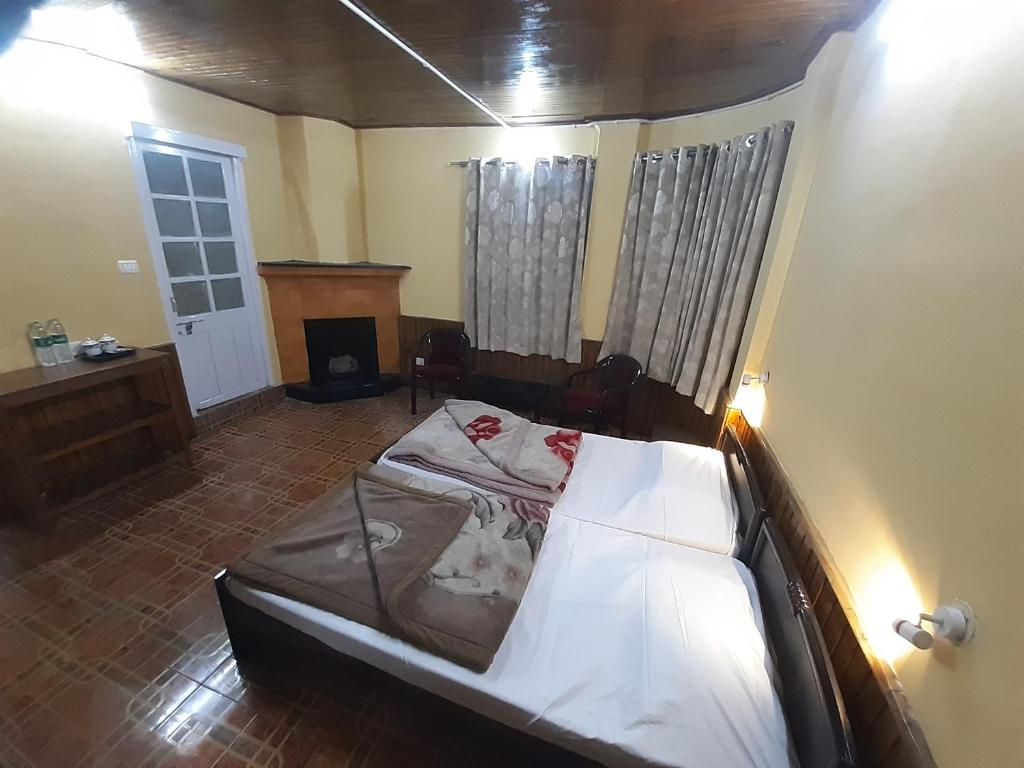 a bedroom with a bed in a room at Himalayan Heritage Stay in Darjeeling
