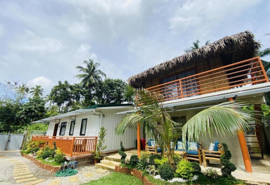 a house with a thatched roof at Birbeck Lodge in Bulusan