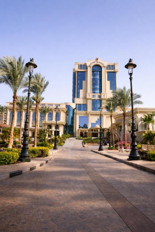 a street in front of a building with palm trees at Grand Tibarose Hotel in Cairo