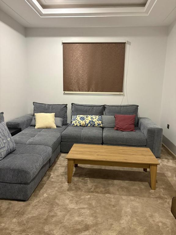 a living room with a couch and a coffee table at Talya Apartment in Mecca