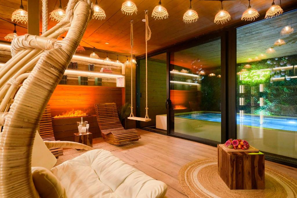 a living room with a hammock and a swimming pool at Les cottages du parc in Roubaix