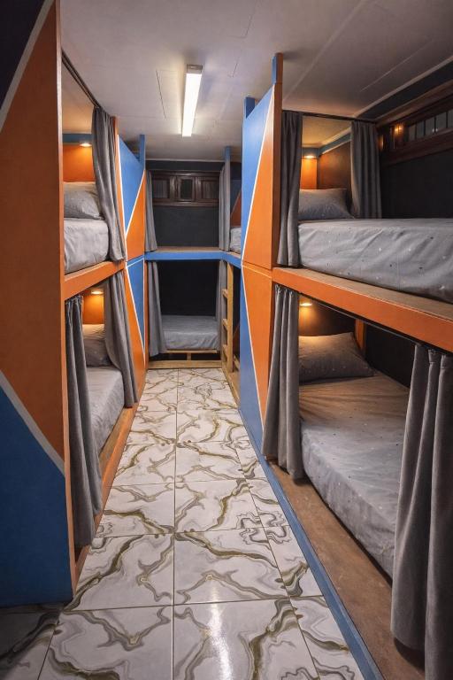 a room with two bunk beds and a tile floor at Complexe Smile & Be in Yaoundé