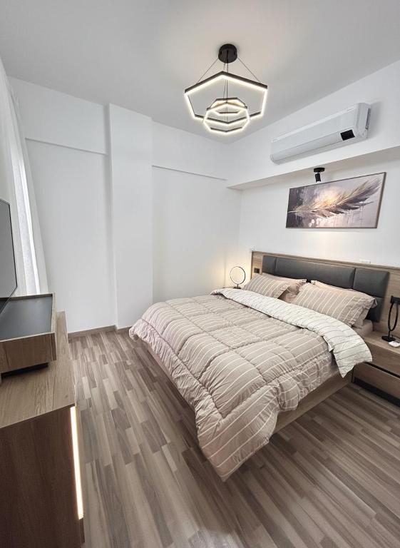 a white bedroom with a large bed in it at Modern apartment Madinaty in New cairo