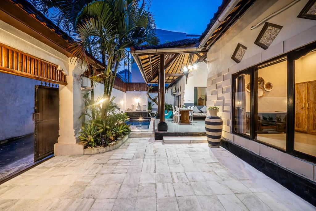an indoor courtyard of a house with a patio at Villa Papat Seminyak in Seminyak