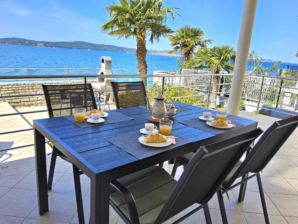 a blue table with food on top of a balcony at Beach House Adria in Bibinje