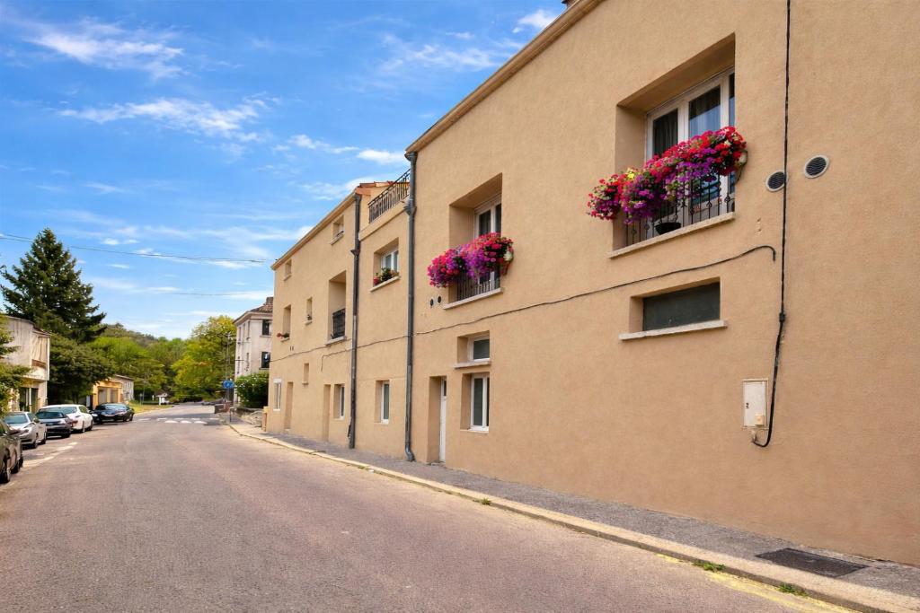 a building with flower boxes on the side of it at Coeur Cevennes in La GrandʼCombe