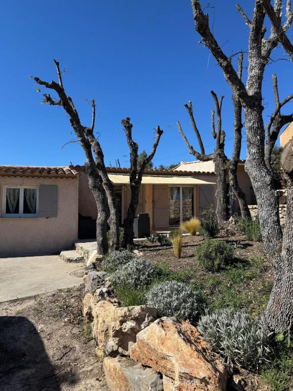 a home in the desert with trees and rocks at Maison 4 personnes in Saint-Julien