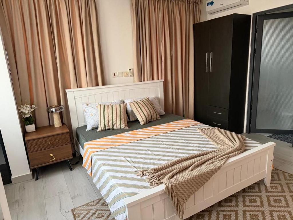 a bedroom with a large bed with pillows on it at 1 Pees Place in Christiansborg