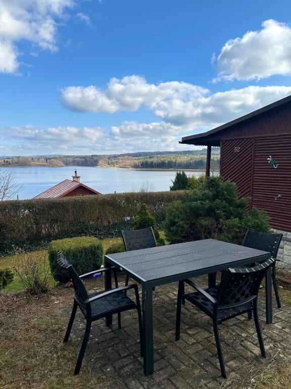 a picnic table and chairs with a view of a lake at Katka in Cheb