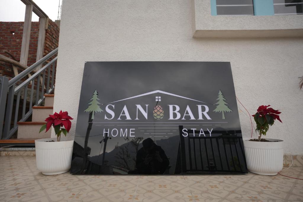 a sign for a san bar sign in front of a house at Sanobar Home Stay in Bhīm Tāl