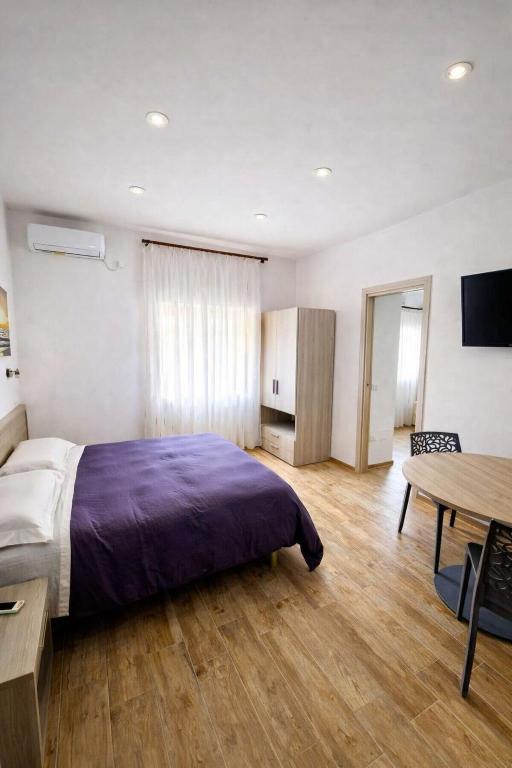 a bedroom with a bed and a table in it at Villa Merina in Vieste