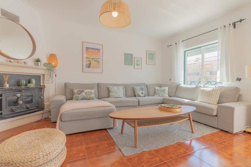 a living room with a couch and a coffee table at Baleal Happiness Surf House in Baleal