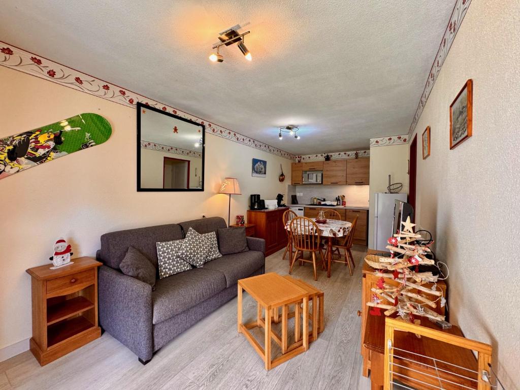 a living room with a couch and a table at Charmant logement de plain-pied avec Piscine in Loudenvielle