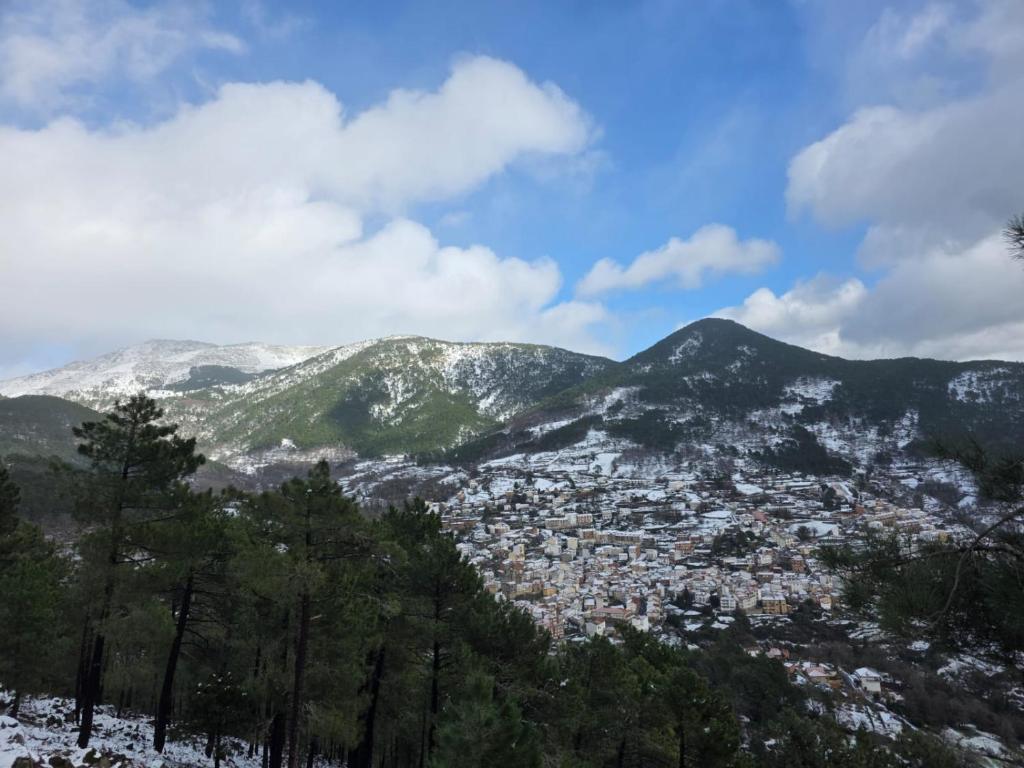 a view of a city with snow covered mountains at Mabel House Sierra de Gredos in Mijares