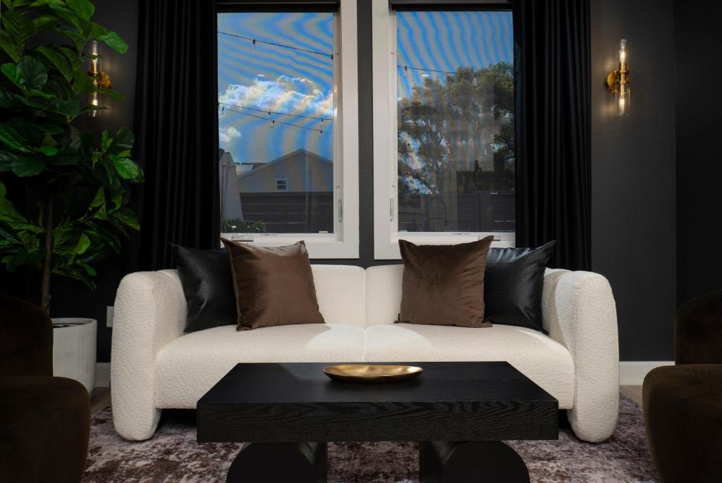 a white couch in a room with a window at 3BR & 3BA Downtown Modern Artsy Home Fully Equipped with Patio in Tampa