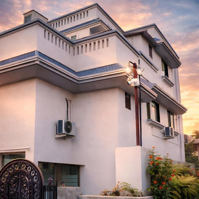 a white building with a speaker on it at Hotel Vyankatesh Inn in Nashik