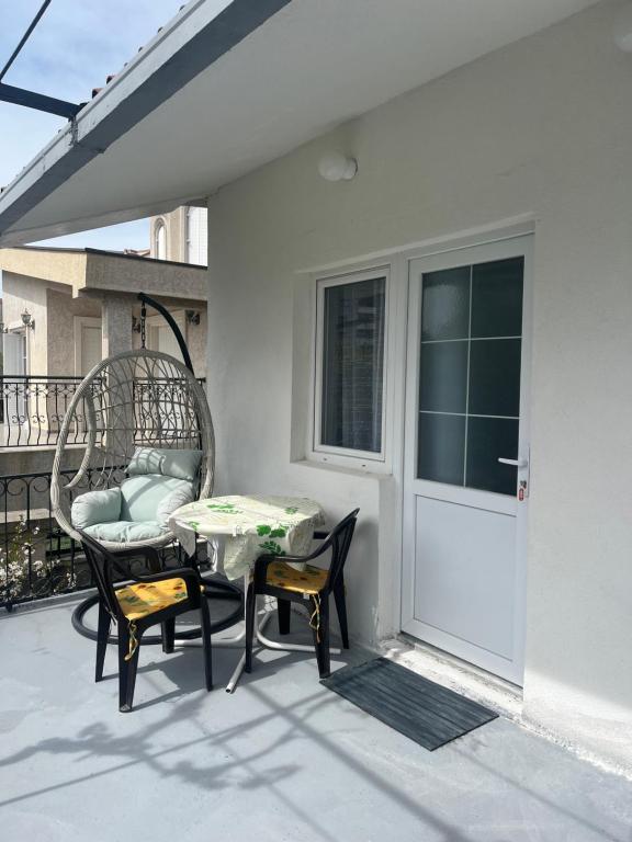 a patio with a table and chairs on a balcony at White Rose 2 in Bar