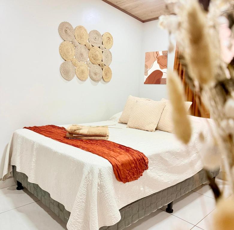 a bedroom with a bed with a blanket on it at Apartamento #10 in Alajuela