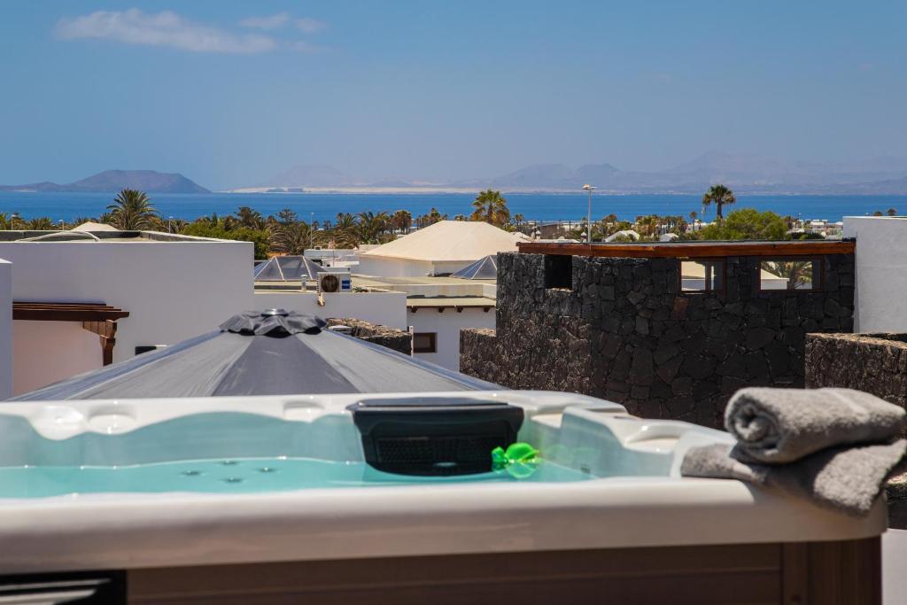 a bath tub sitting on top of a roof at Villa Amana 5 star luxury resort for 10 people in Playa Blanca in Playa Blanca