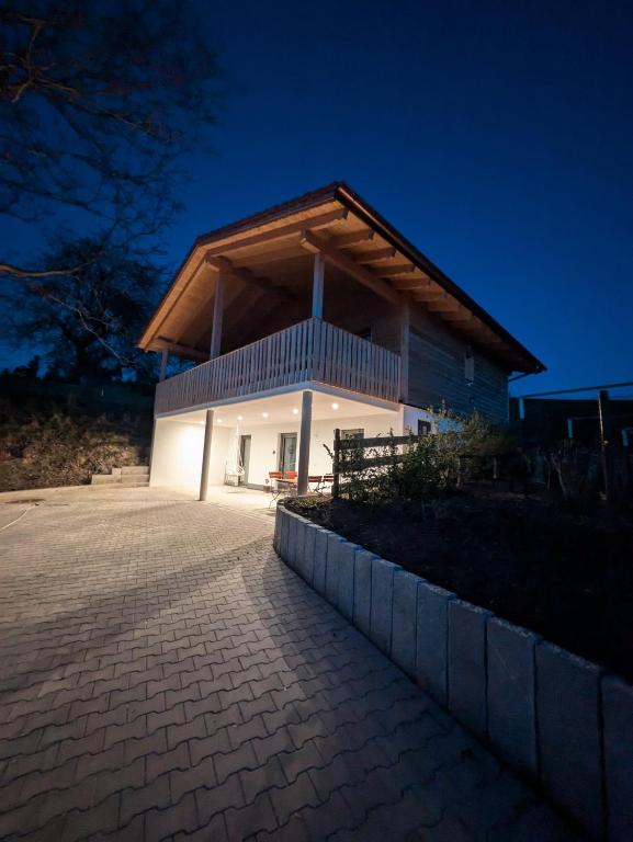 a house with a lit up facade at night at Brunner Alm in Obertaufkirchen