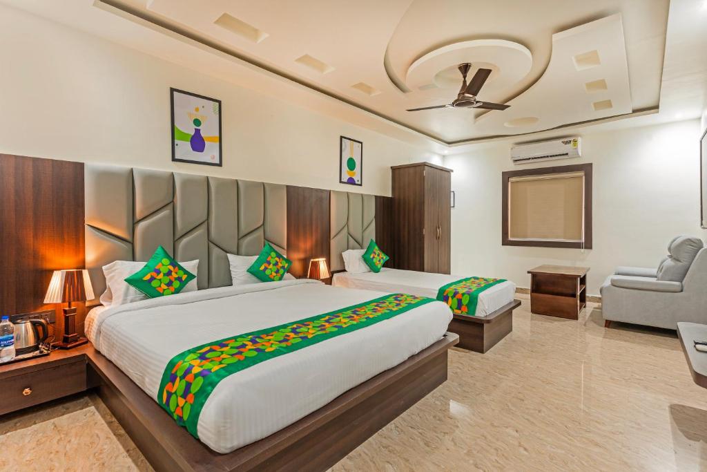 a hotel room with a large bed and a chair at Treebo Sloka Residency in Rānchī