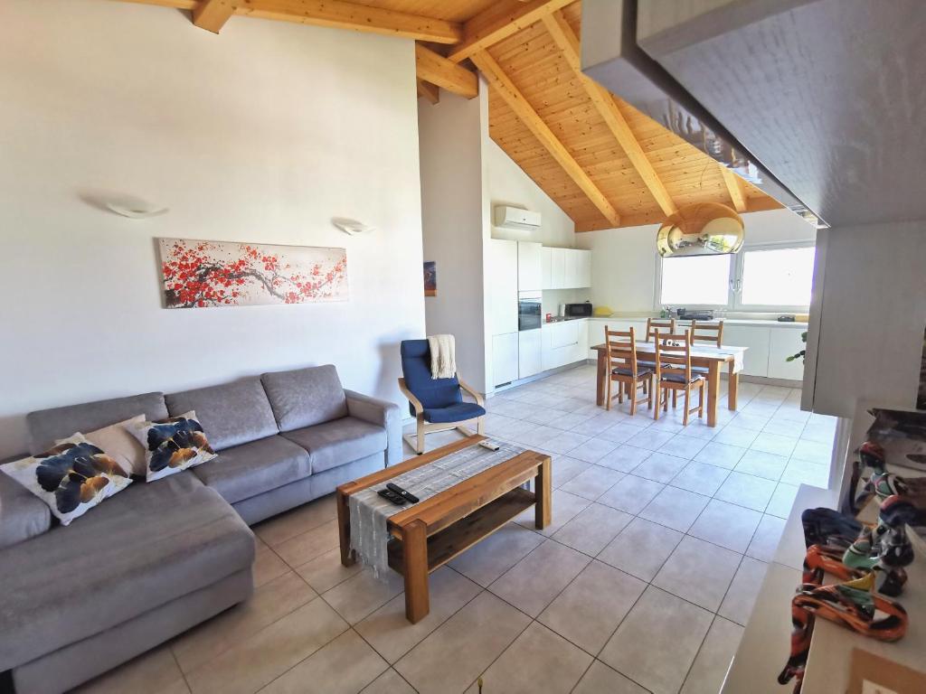 a living room with a couch and a table at Ca Mea - Lake View, Parking, EV in Gordola