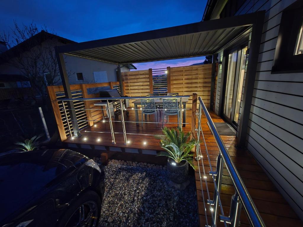 a deck with a table and chairs on it at Tiny House Annecy in Annecy
