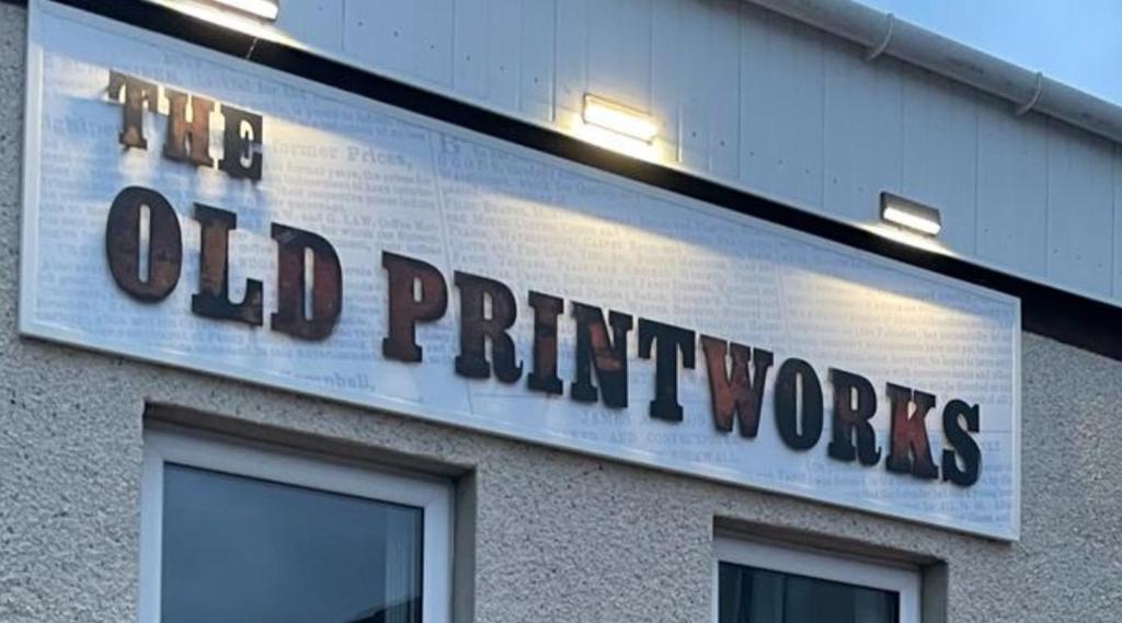 a sign on the side of a old principal works building at The Old Printworks, Kirkwall in Orkney