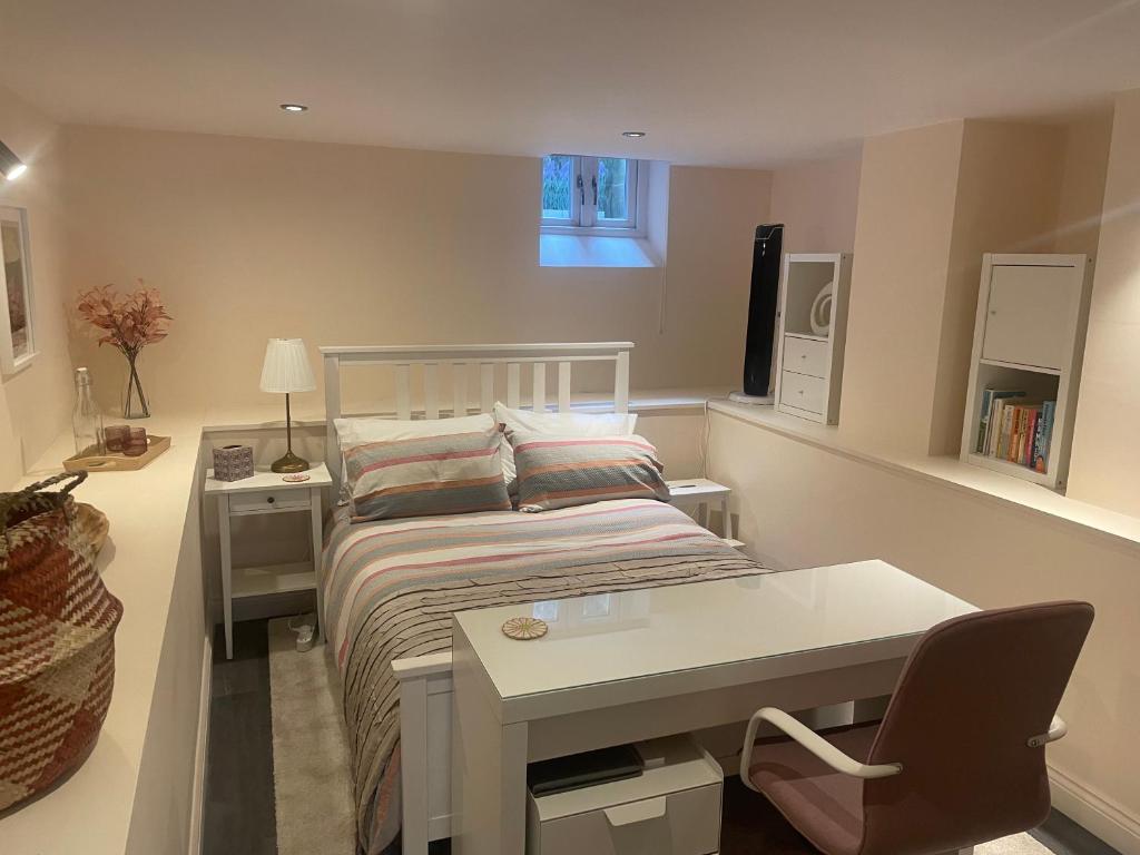 a small bedroom with a bed and a desk at Trailside in Headingley in Leeds
