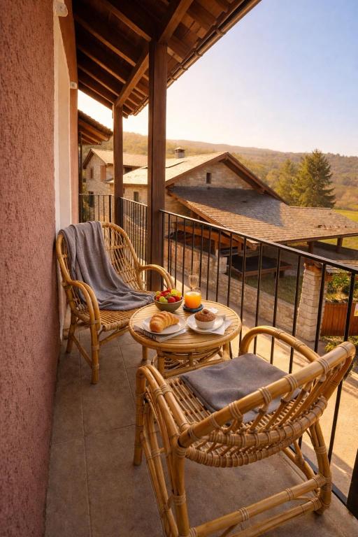a balcony with two chairs and a table with oranges on it at Casa en Vilallobent Cerdanya ideal familias by CalQuerol in Vilallovent