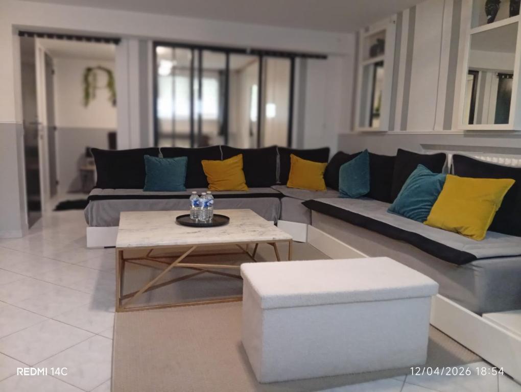 a living room with a couch and a coffee table at Large Studio in a cozy house in Ormesson-sur-Marne