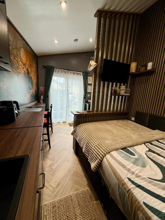 a bedroom with a large bed and a desk and a desk at The NOOK in Kinlochleven