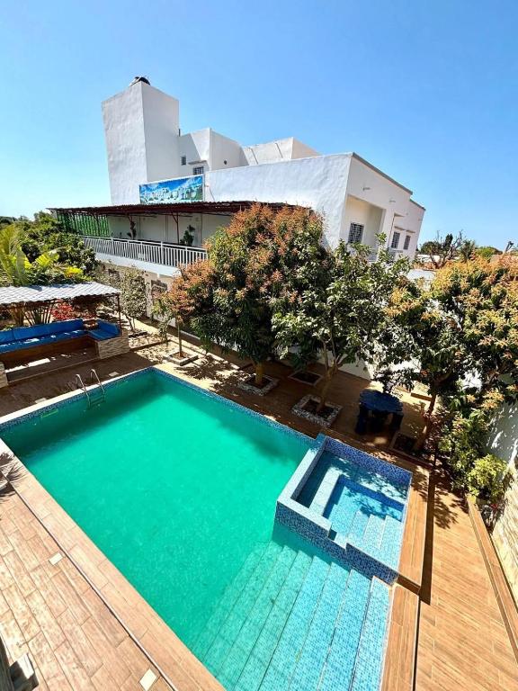 an overhead view of a swimming pool in front of a building at Villa Nostra in Ngaparou