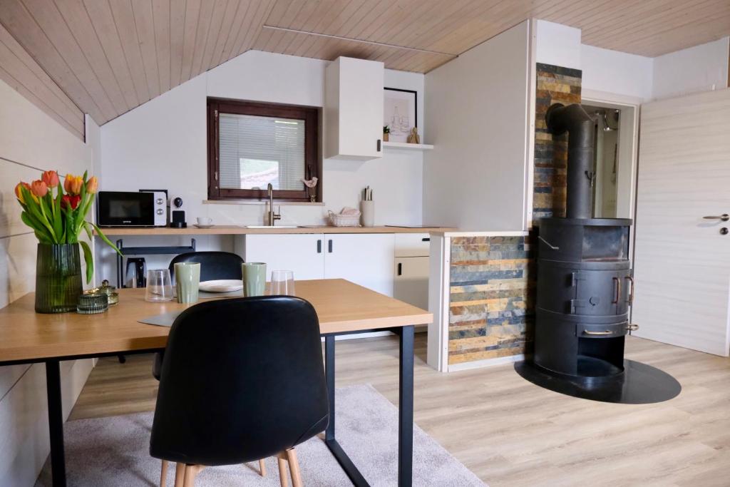 a kitchen with a table and a wood stove at Apartments Hana Bled in Bled