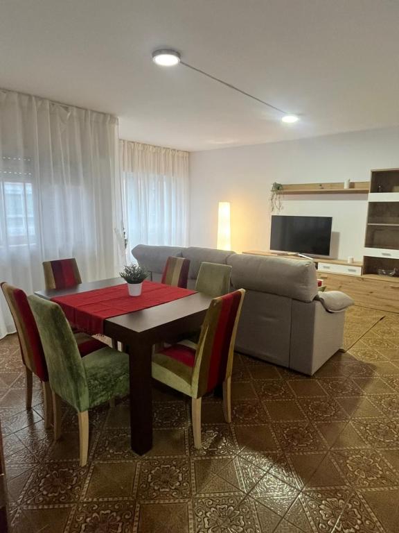 a living room with a table and a couch at O Repouso in Lalín