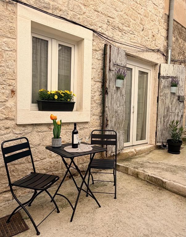 a table and chairs on a patio with a window at Casa Blu in Šibenik